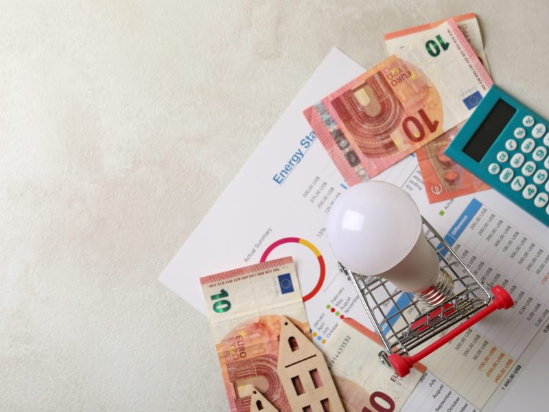 Concept of energy saving on white textured table.